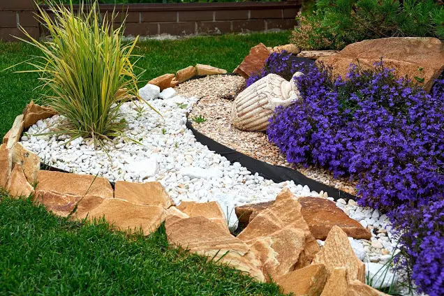 Sandstones, White Rocks and purple flowers - front yard landscaping