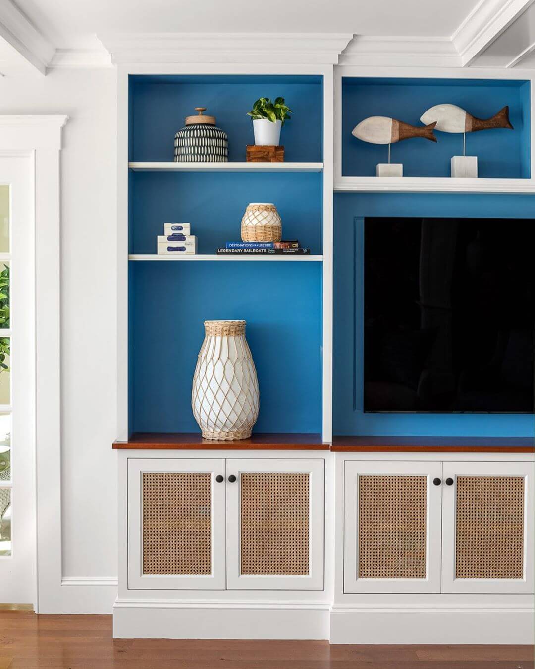 Coastal Living Room with Teal Paint behind Built in Shelves