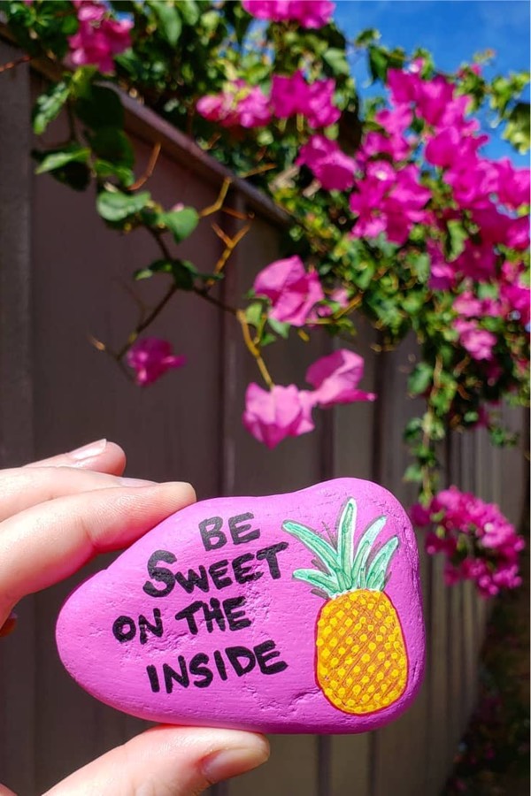 pink painted pebble with quote