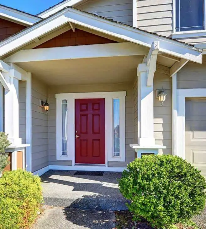 Entrance porch of a modern house with red front door