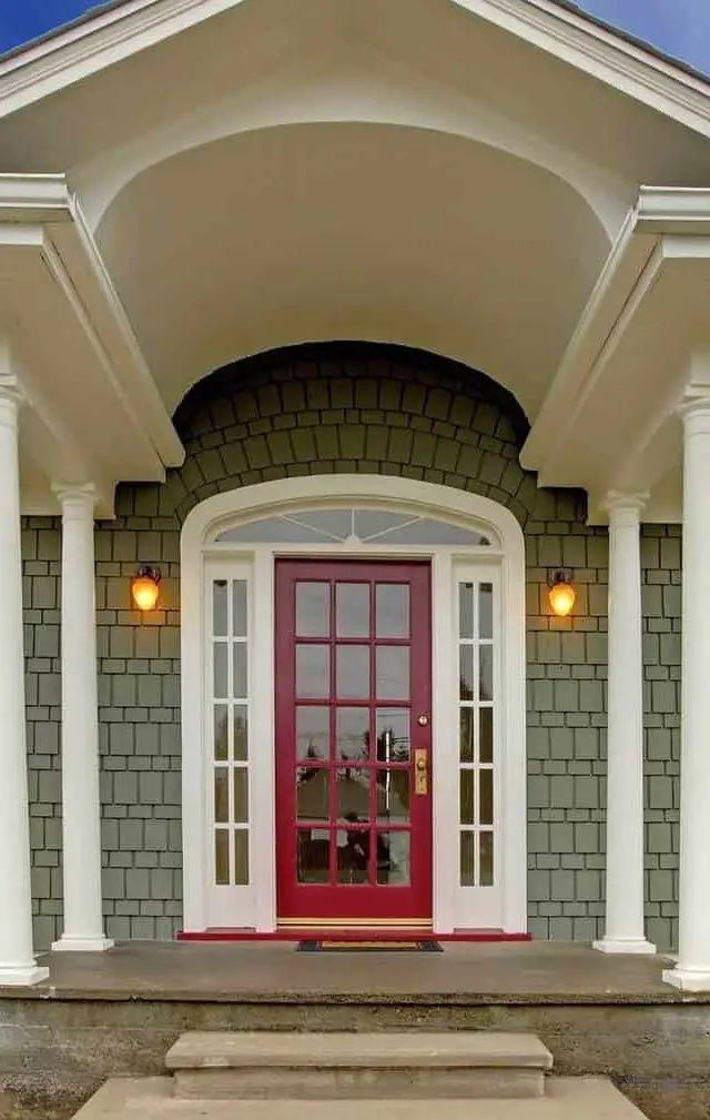 Small cute grey New England style home with pink red door