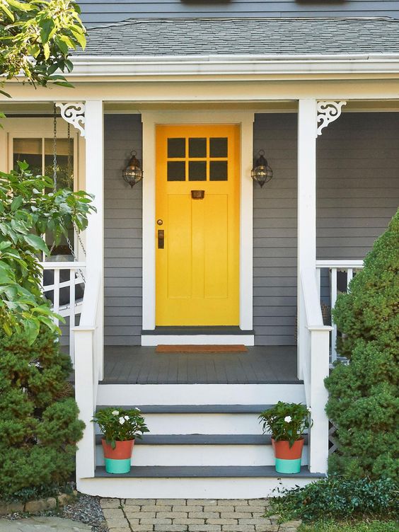charming yellow front door color for a gray house