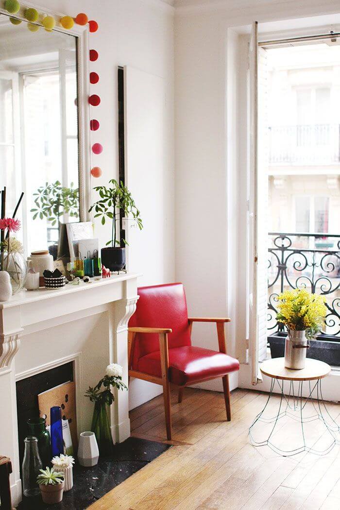 Parisian living room with red leather accent chair