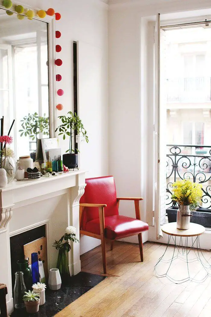 Parisian living room with red leather accent chair