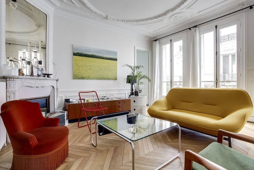 Parisian living room with modern mustard yellow sofa