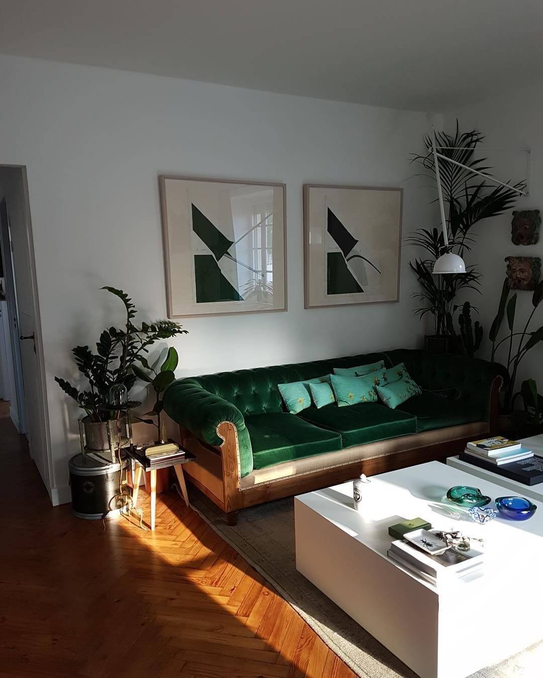 Parisian living room with green velvet sofa
