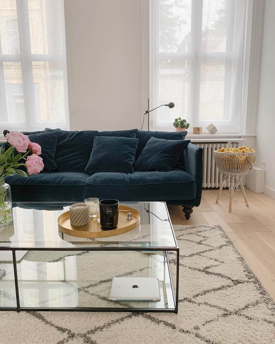 Parisian living room with dark blue velvet sofa
