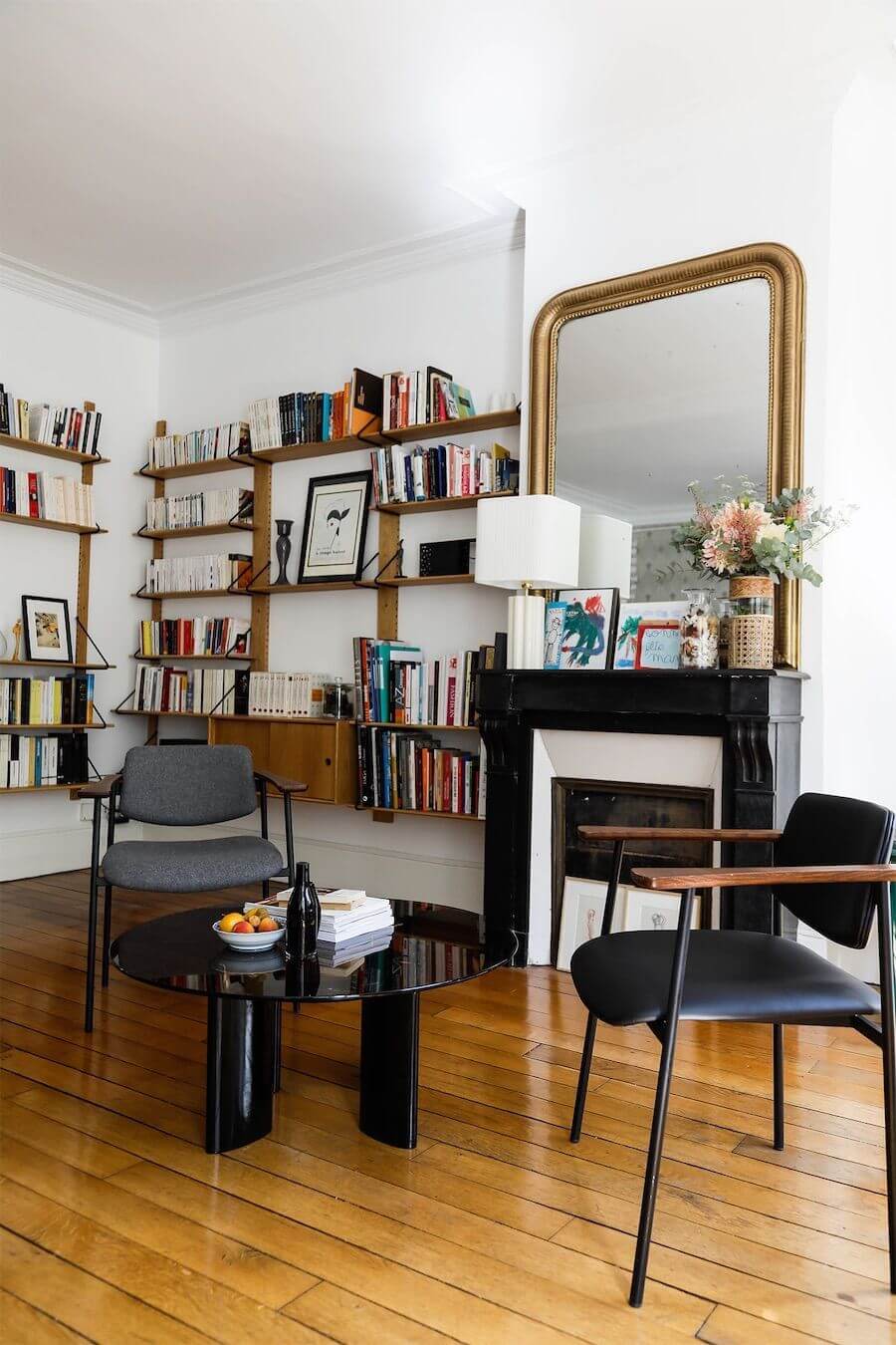 Parisian living room with black accent chairs black accent table and black fireplace