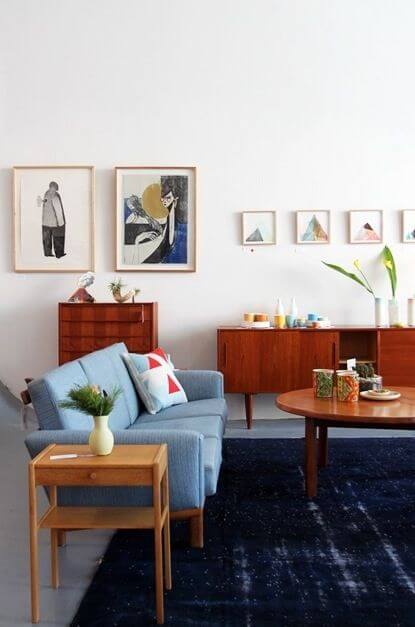 Mid Century Modern Living Room with Navy Rug and Wood Sideboard