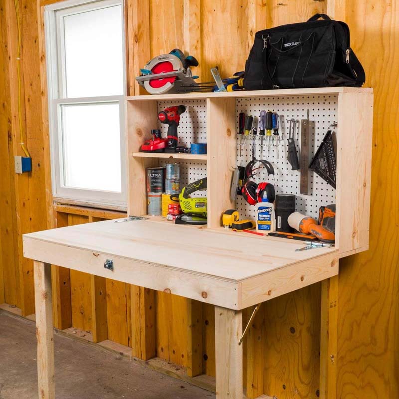 A small wooden workbench on the wall of a shed, holding various tools and supplies for projects. 