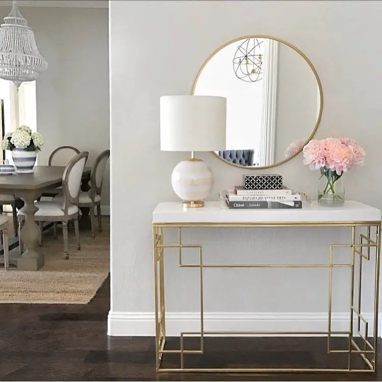 Elegant entryway table with a luxurious marble top and gold accents