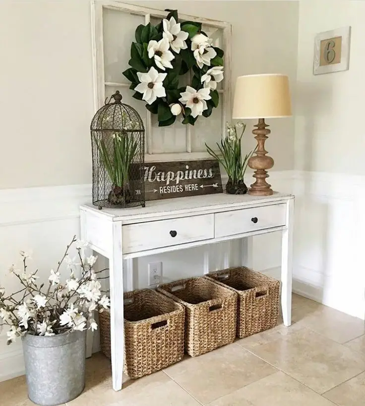Entryway table adorned with potted plants and lush greenery for a fresh ambiance