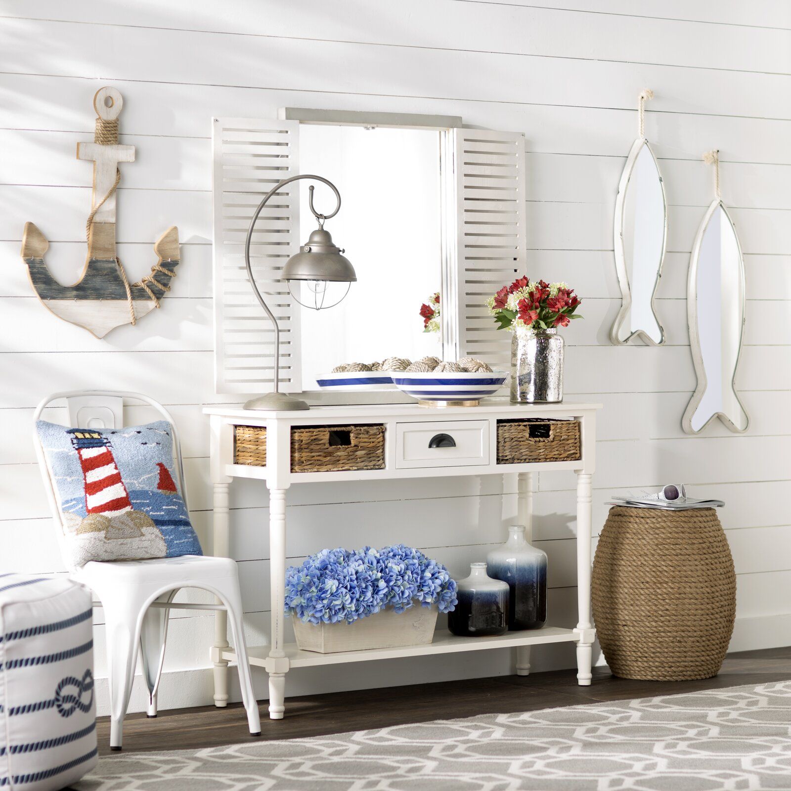 Entryway table featuring a coastal theme with seashells and nautical decor
