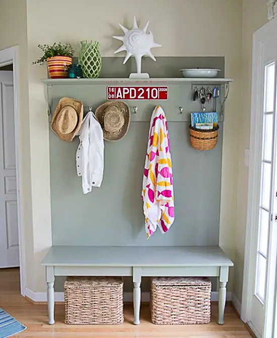 Entryway table featuring hanging wall hooks for convenient coat and bag storage