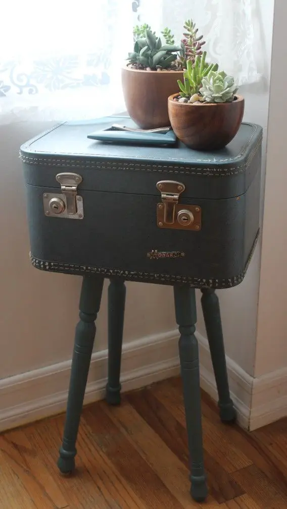 Entryway table incorporating a vintage suitcase for stylish and practical storage