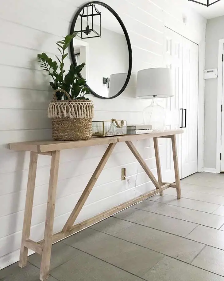 Narrow entryway table designed to save space in a compact foyer