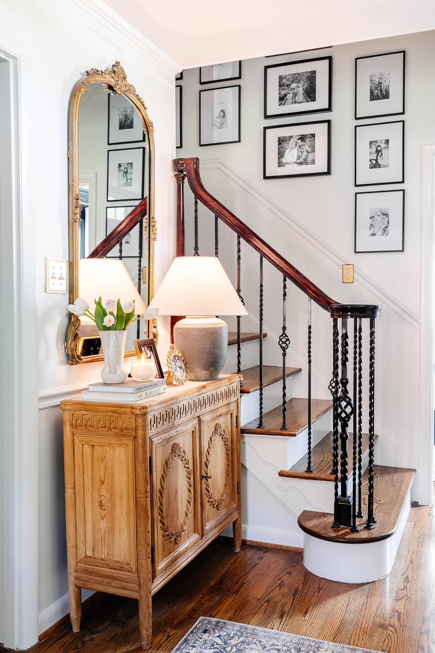 Entryway table illuminated by a stunning statement lighting fixture