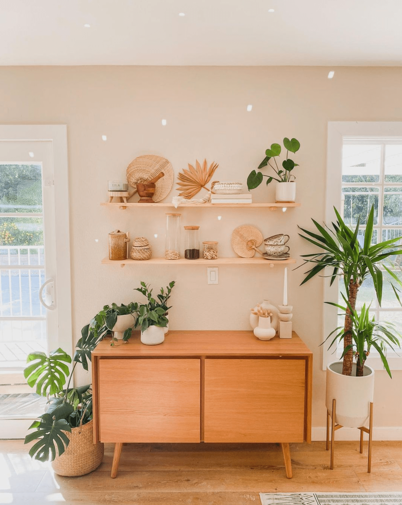 Entryway table complemented by floating shelves for additional storage and display