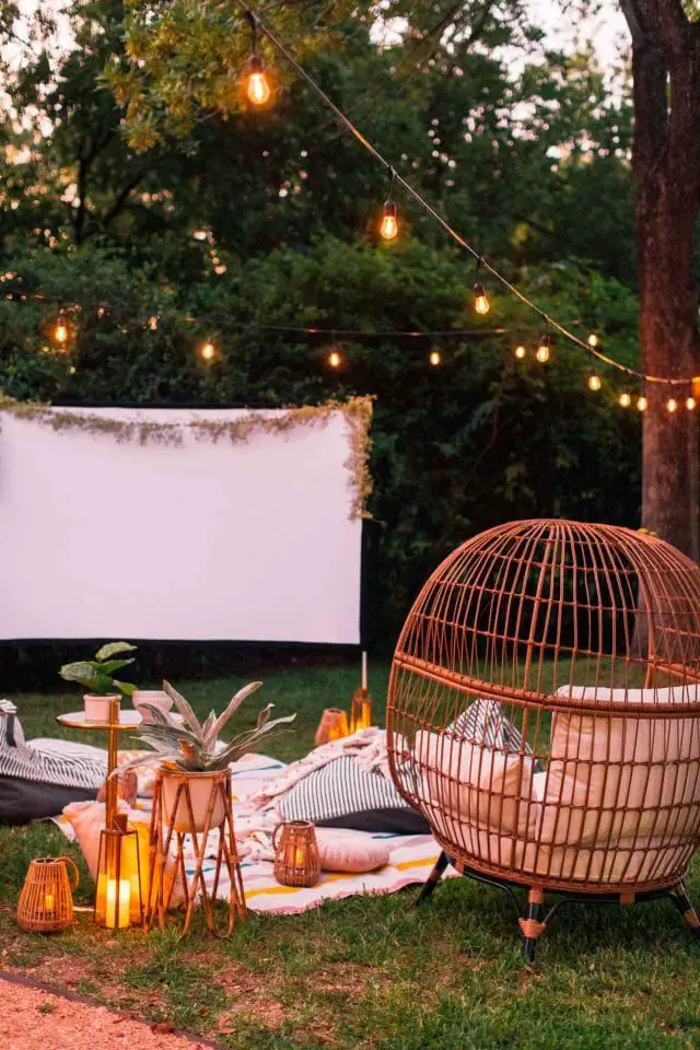 A backyard movie with chairs and a screen