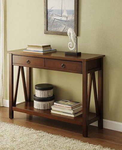 Entryway table featuring a stack of stylish coffee table books for visual interest
